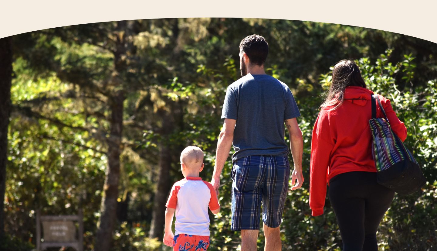 Family holding hands and walking away 